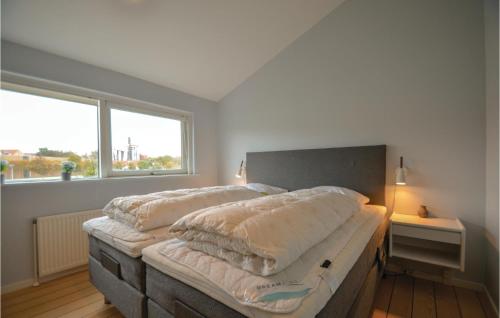 a bedroom with a large bed with pillows on it at Beautiful Apartment In Ebeltoft With 2 Bedrooms, Sauna And Wifi in Ebeltoft