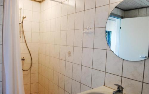 a bathroom with a sink and a mirror at 2 Bedroom Cozy Apartment In Hvide Sande in Havrvig