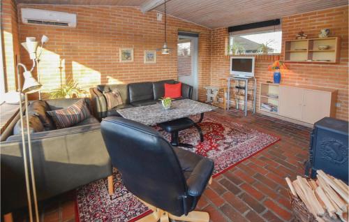 a living room with a couch and a table at Two-Bedroom Holiday Home In Sydals in Skovbyballe