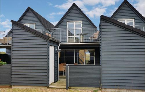 a house with black siding at Hus R in Henne Strand