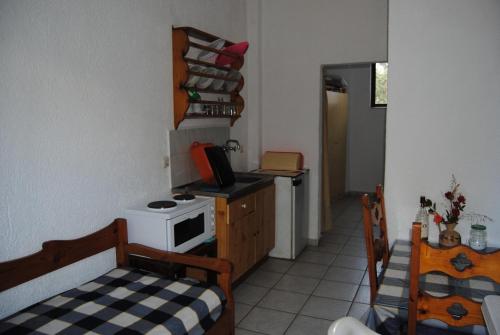 a small kitchen with a stove and a microwave at Sailors Apartments in Elounda