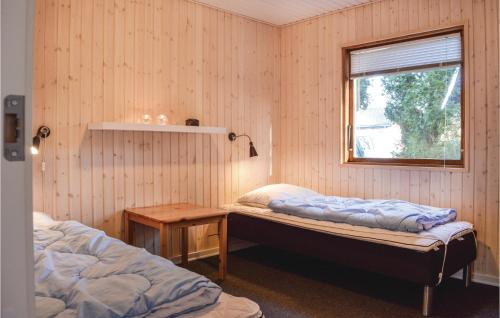 a bedroom with two beds and a window at Three-Bedroom Holiday Home In Vejby in Vejby