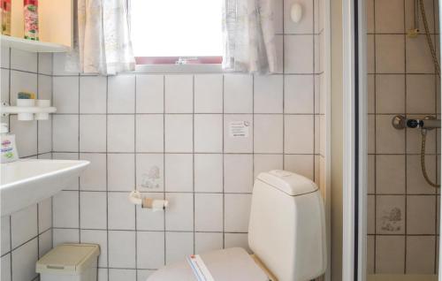 a white bathroom with a toilet and a window at Stunning Home In Lgstr With 2 Bedrooms And Wifi in Trend