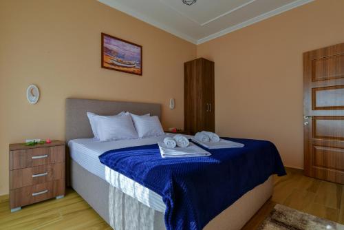 a bedroom with a bed with towels on it at Apartments Hillside in Ulcinj