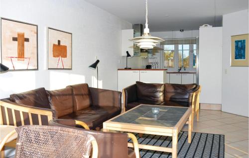 a living room with leather furniture and a table at Holiday Home Sdr Frankel Rømø Denm in Havneby