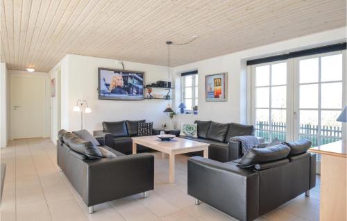 a living room with couches and a table at Five-Bedroom Holiday Home In Ulfborg in Ulfborg