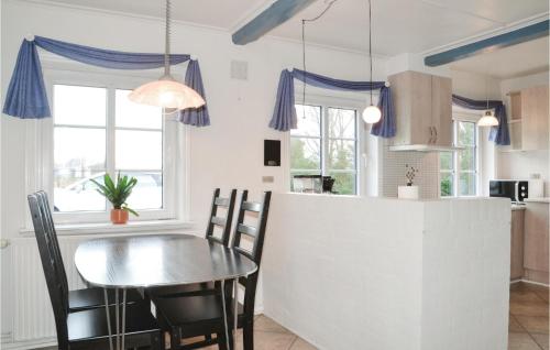 a kitchen and dining room with a table and chairs at Gorgeous Home In Bramming With Sauna in Bramming