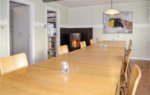a dining room with a large wooden table and chairs at Gorgeous Home In Bramming With Sauna in Bramming