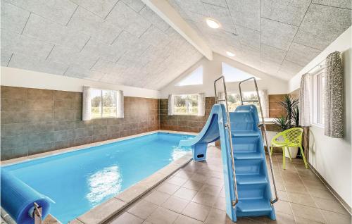 a swimming pool with a slide in a house at Lovely Home In Nørre Nebel With Wifi in Nørre Nebel