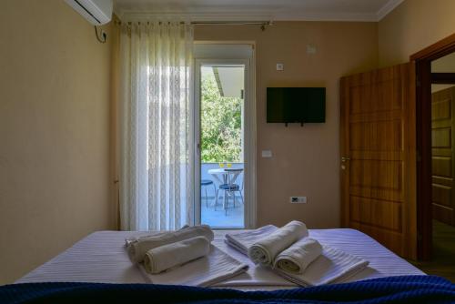 a bedroom with a bed with towels on it at Apartments Hillside in Ulcinj