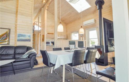 a dining room and living room with a table and chairs at Holiday Home Ildervej I in Hemmet