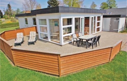 a large deck with a table and chairs on it at Mindegården in Hejls