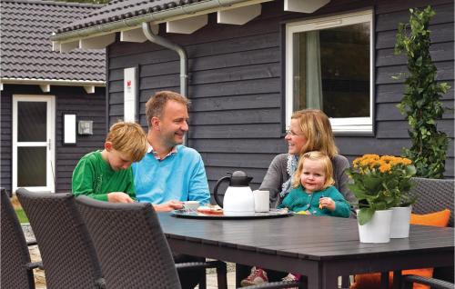 a family sitting at a table eating food at a table at Beautiful Home In Sydals With Wifi in Høruphav