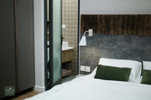 Ένα ή περισσότερα κρεβάτια σε δωμάτιο στο Kaia Residence Danang Quiet Garden