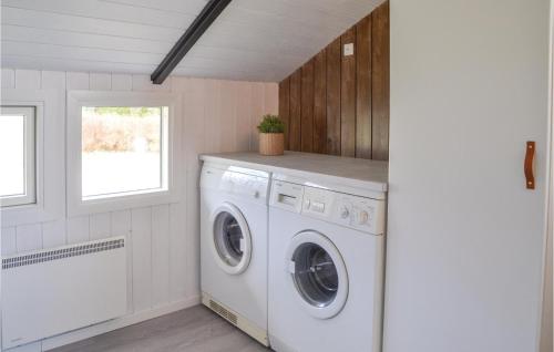 a laundry room with a washing machine and a window at Holiday Home Møllevangen Ix in Ovtrup