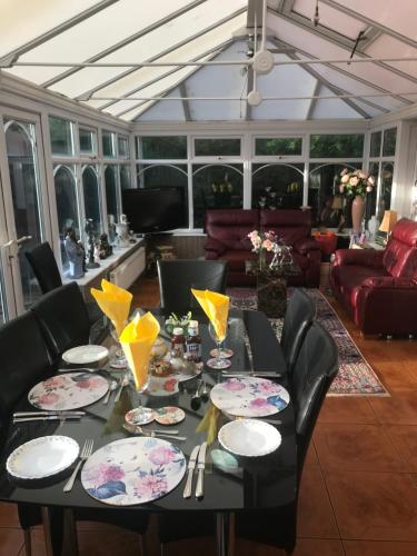 a dining room with a black table and chairs at Redwood Lodge in Westbury