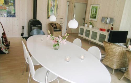 a white table and chairs in a living room at Holiday Home Bæverstien Denm Iv in Marielyst