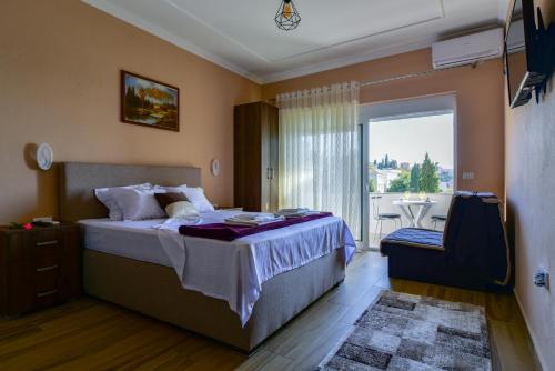 a hotel room with a bed and a balcony at Apartments Hillside in Ulcinj