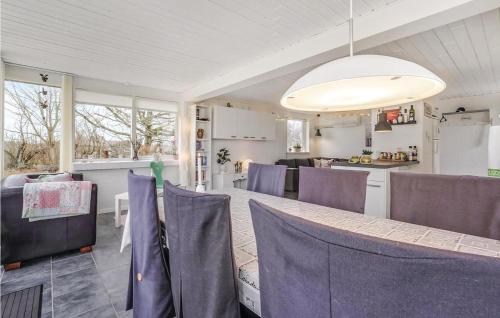 a dining room and kitchen with a table and chairs at Two-Bedroom Holiday Home In Spottrup in Spottrup