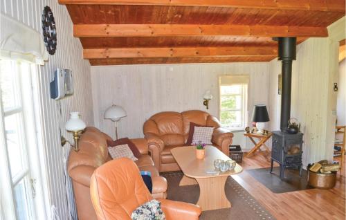 a living room with leather chairs and a table at Holiday Home Bøtø Ringvej in Marielyst