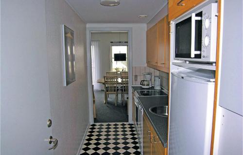 a kitchen with a black and white checkered floor at Apartment Skudehavnen Rudkøbing in Rudkøbing