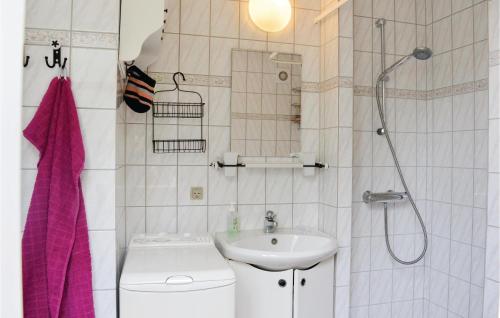a bathroom with a sink and a toilet and a shower at Lovely Home In Rm With Wifi in Bolilmark