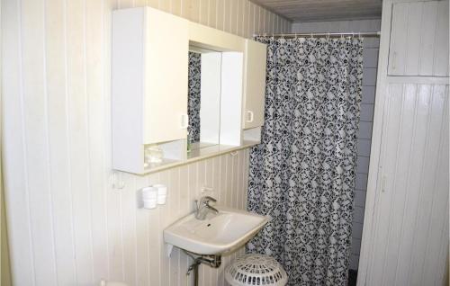 a bathroom with a sink and a shower curtain at Stunning Home In lbk With 3 Bedrooms in Skram