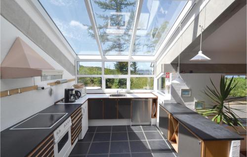 an attic kitchen with a large skylight at Holiday Home Hesselvej in Hvalpsund