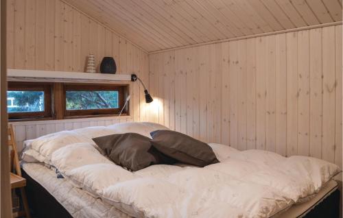 a large bed in a room with a wall at Three-Bedroom Holiday Home In Vejby in Vejby