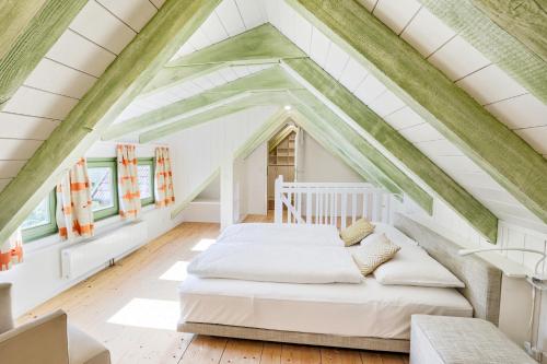 ein Schlafzimmer mit einem Bett im Dachgeschoss in der Unterkunft MALAT Ferienhaus in Furth