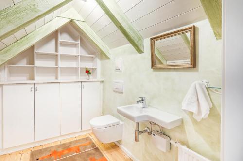 a bathroom with a sink and a toilet at MALAT Ferienhaus in Furth