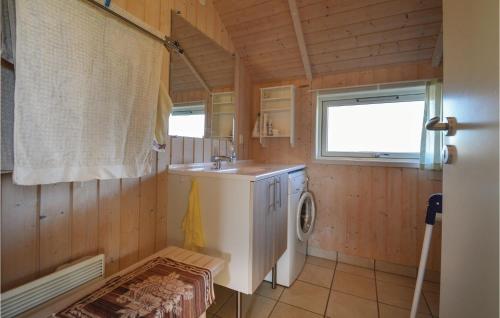 a bathroom with a sink and a washing machine at 2 Bedroom Awesome Home In Hovborg in Hovborg