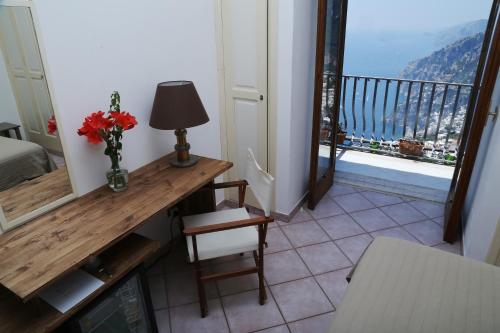 
a living room filled with furniture and a window at Colle dell'Ara in Positano
