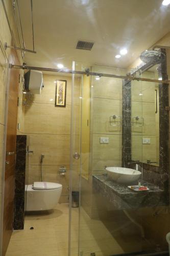 a bathroom with two sinks and a glass shower at HOTEL ROYAL HILLTON in Pāonta Sāhib