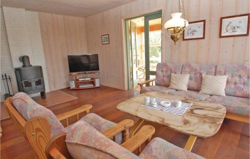 a living room with a couch and a coffee table at Mindegården in Hejls