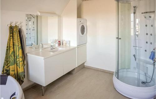 a white bathroom with a sink and a shower at Four-Bedroom Holiday Home In Ulfborg in Øhuse