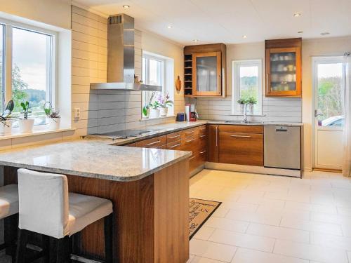 a kitchen with a large island in the middle at 10 person holiday home in KLÖVEDAL in Klövedal