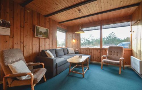 a living room with a couch and two chairs and a table at Holiday Home Ringvejen Rømø Ix in Rømø