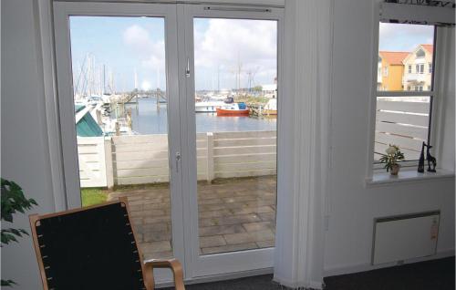 a door with a window with a view of a marina at Apartment Skudehavnen Rudkøbing in Rudkøbing