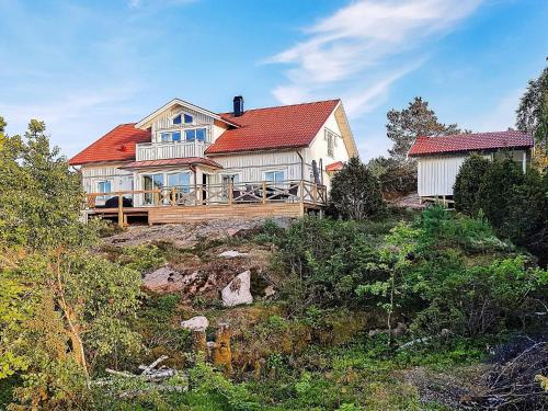 a large white house with a red roof on a hill at 10 person holiday home in KLÖVEDAL in Klövedal