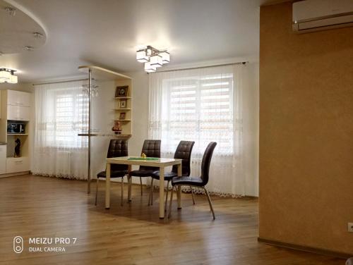 a dining room with a table and chairs at Apartment on Zhaloytskaga 35 in Pinsk