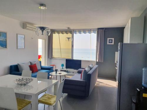 a living room with a table and chairs and a dining room at Sea View Nik Apartment in Durrës