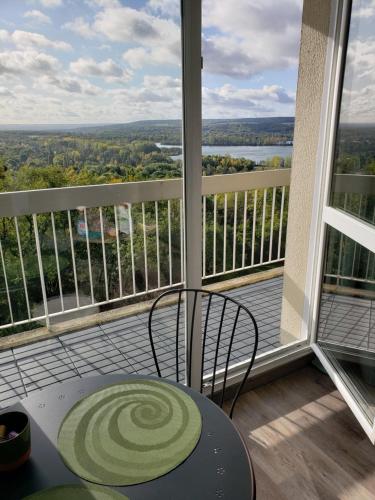 a view of a balcony with a table and chair at COSYLOC studios in Cergy