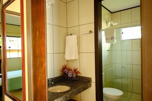 a bathroom with a sink and a toilet and a shower at Resid.l Canto do Encanto in Garopaba