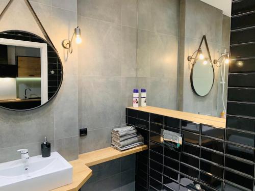 a bathroom with a sink and a mirror at Property Apart - Soft Lofty Legnicka Centrum in Wrocław