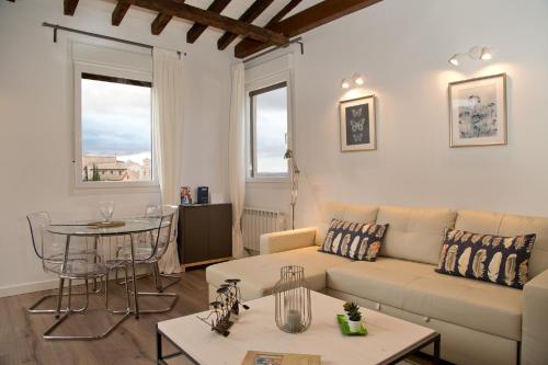 ein Wohnzimmer mit einem Sofa und einem Tisch in der Unterkunft Atico San Nicolás in Toledo