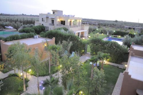 an aerial view of a house with a pool and trees at Villa Haitam Marrakech in Oubadine