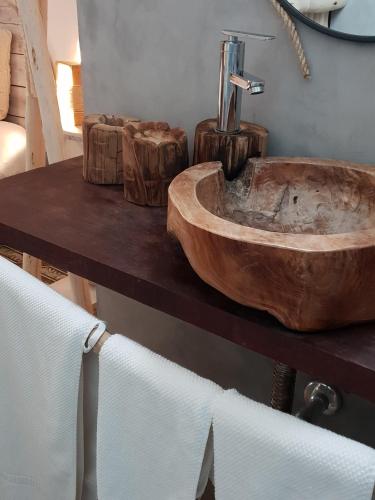 a wooden sink on a table in a bathroom at Cactus Host in Las Palmas de Gran Canaria
