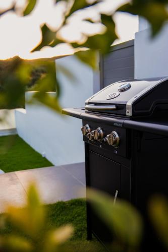 a grill with a phone sitting on top of it at Adrianna Villa 1 in Balíon