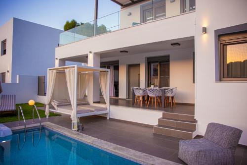 a villa with a swimming pool and a house at Adrianna Villa 1 in Balíon